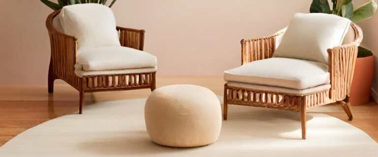 Two chairs with white cushions in a modern living room with a white rug on a wooden floor.