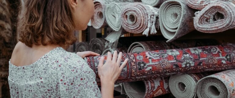 Woman shopping for a rug.