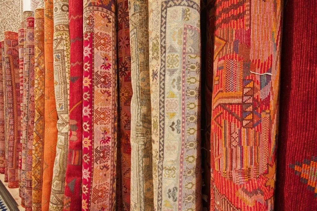 Colorful persian, oriental, and vintage rugs lined up in a row